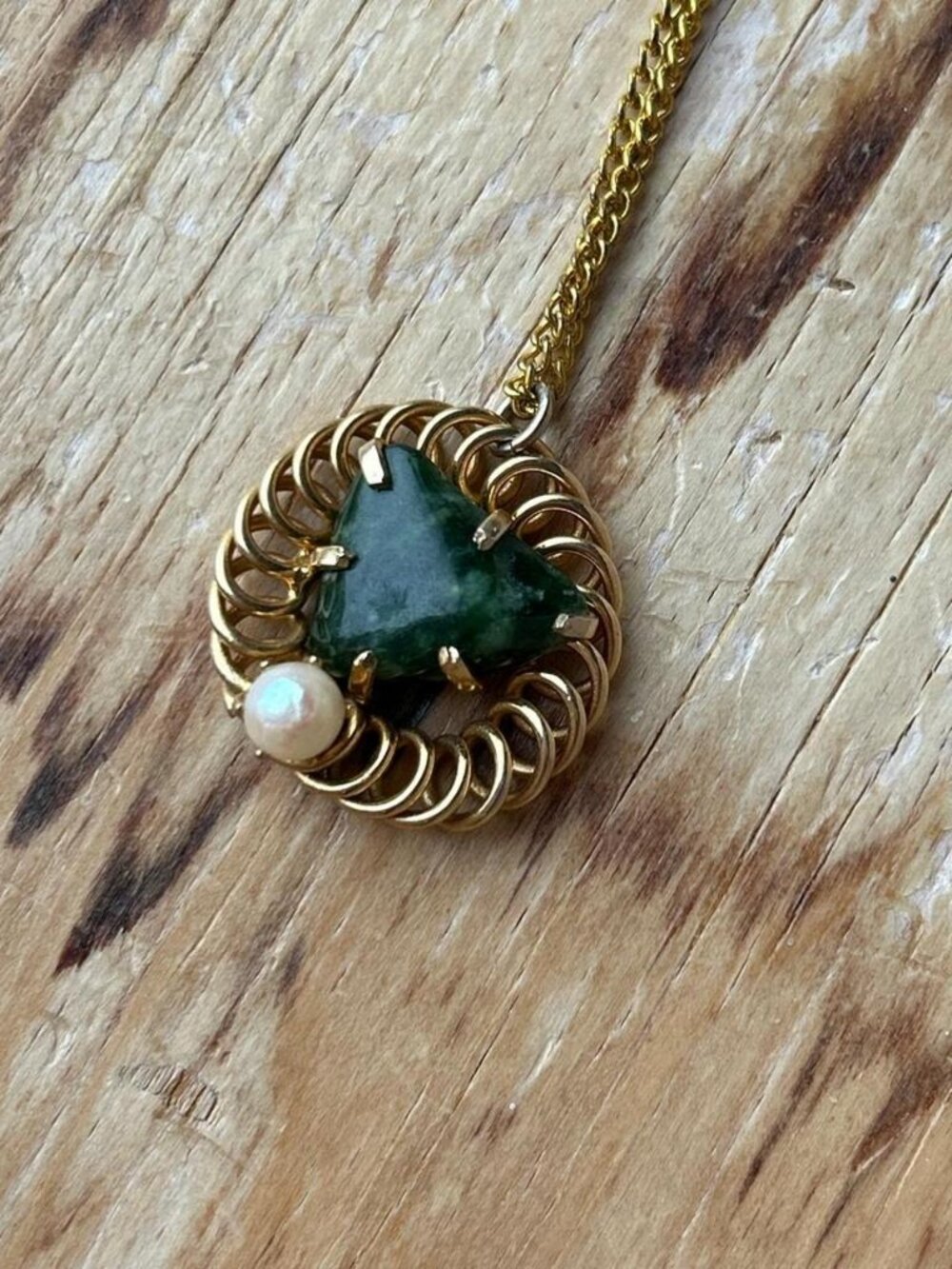 Emerald green stone heart pendant on a gold plated chain